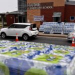 Photo of pallets of bottled water outside Harvie Elementary School
