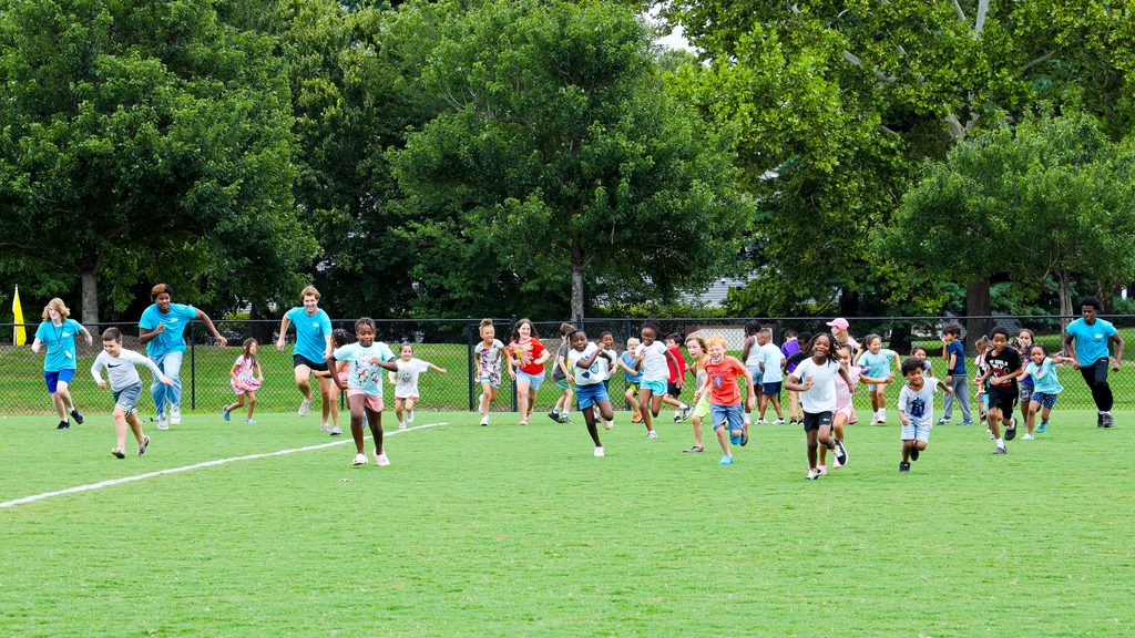 Kids and staff running and playing at Let's Grow, Henrico Summer Camp
