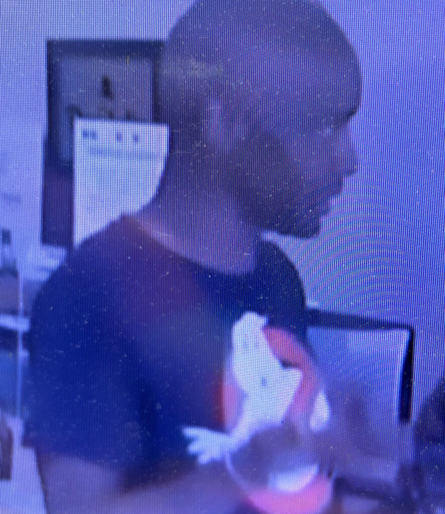 Black man wearing a Ghostbusters shirt.