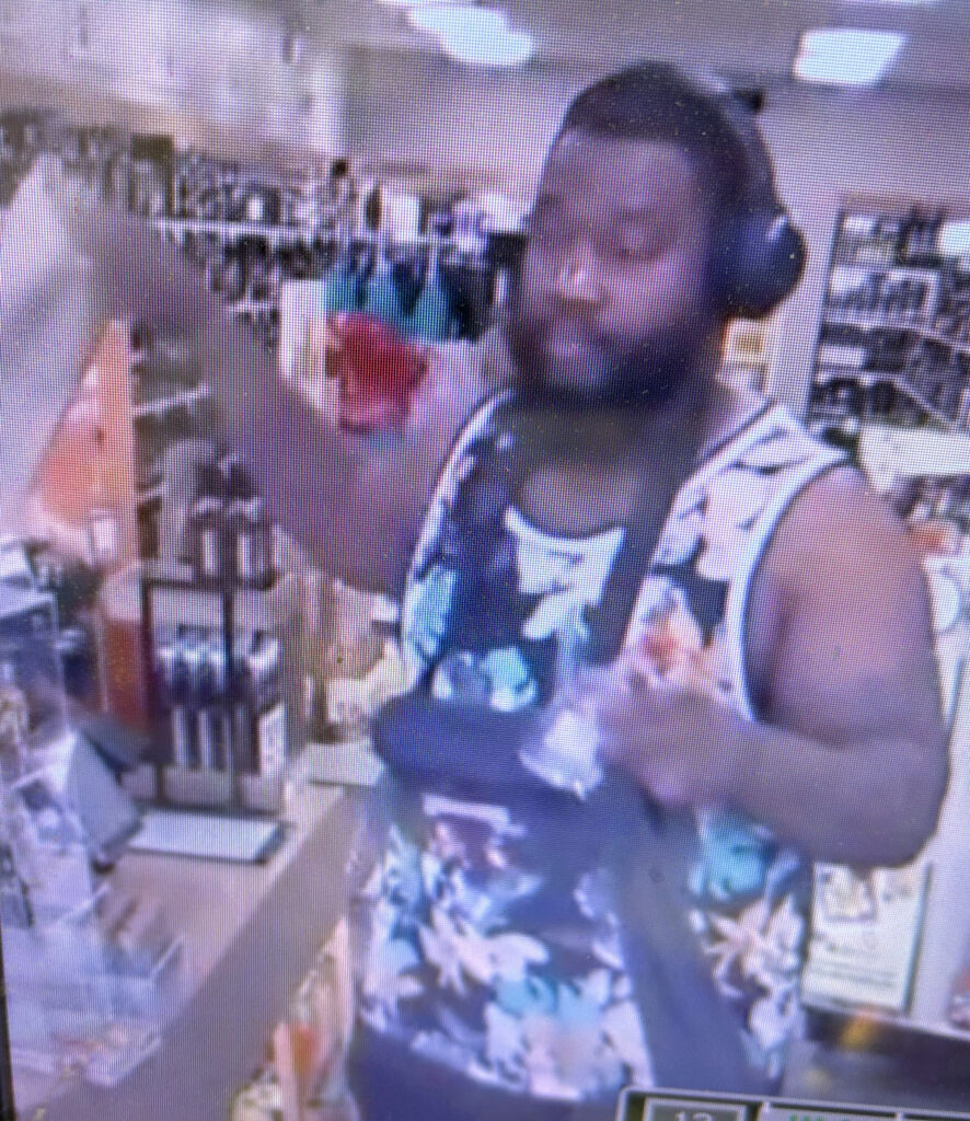 Surveillance photo of a person inside an ABC liquor store.