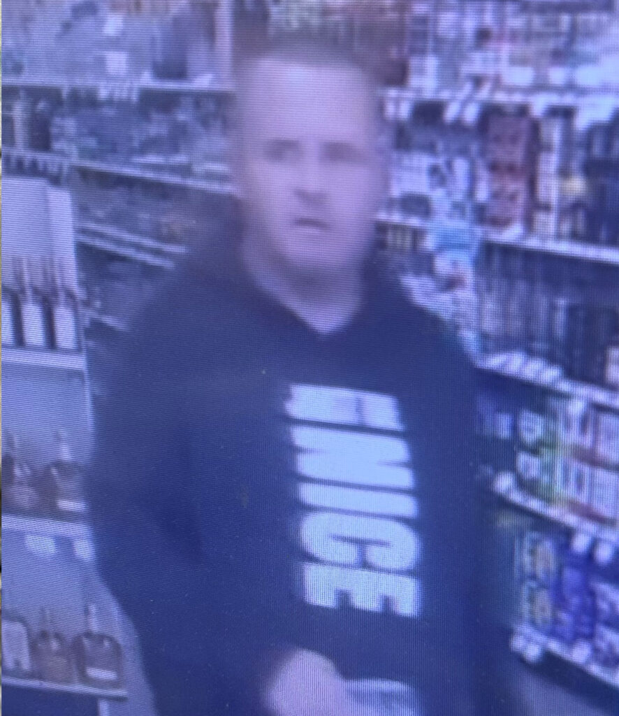 Surveillance photo of a person inside an ABC liquor store.