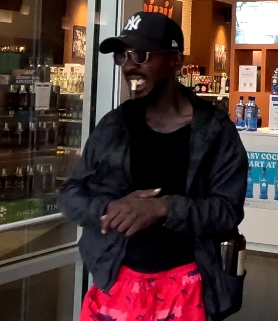 Surveillance photo of a person inside an ABC liquor store.