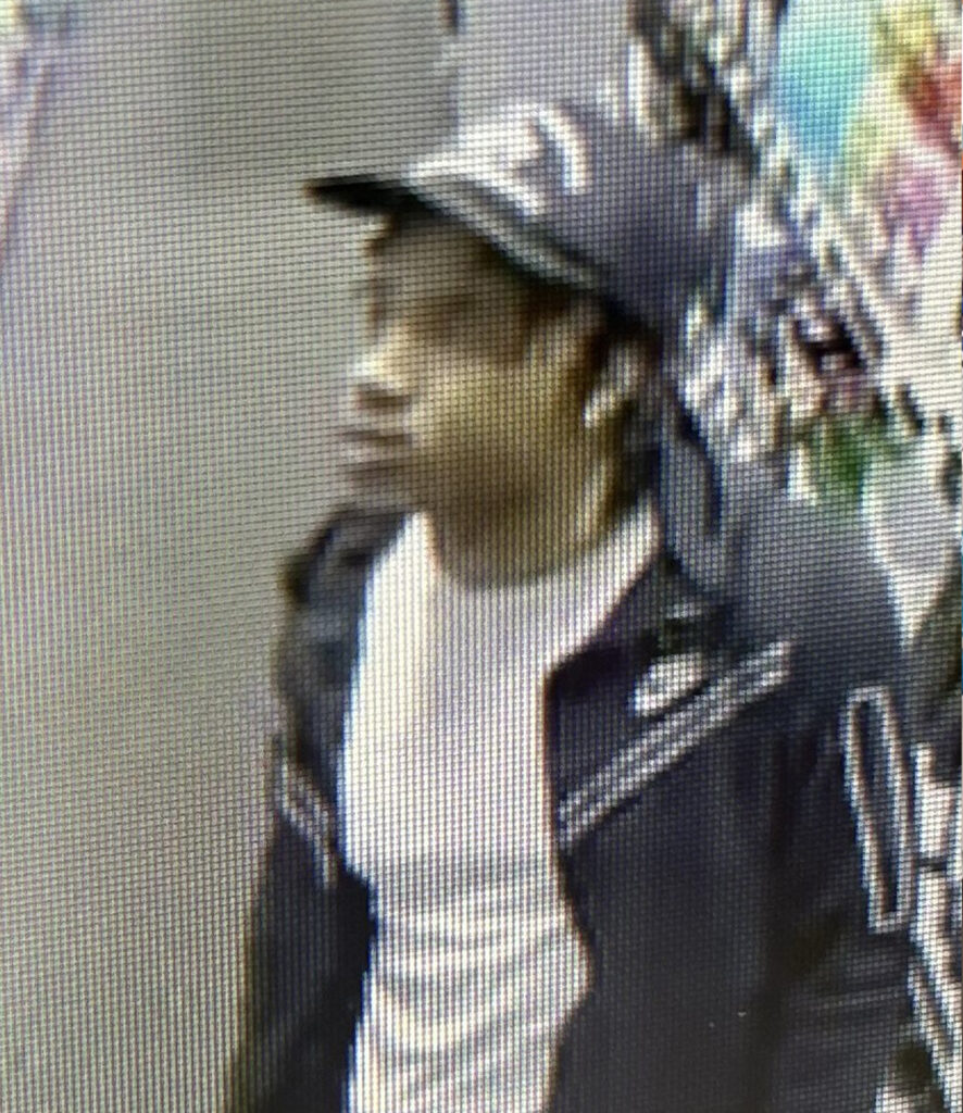 Surveillance photo of a person inside an ABC liquor store.