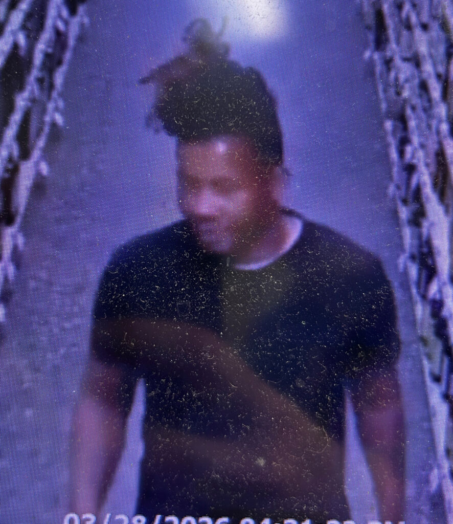 Blurry image of a person of interest for a larceny case with contact info for Metro Richmond Crime Stoppers.