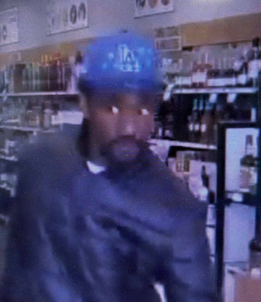 Blurry image of a person of interest for a larceny case with contact info for Metro Richmond Crime Stoppers.