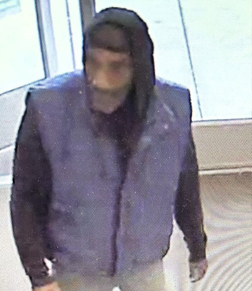 Blurry image of a person of interest for a larceny case with contact info for Metro Richmond Crime Stoppers.