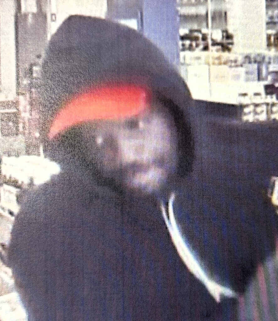 Blurry image of a person of interest for a larceny case with contact info for Metro Richmond Crime Stoppers.