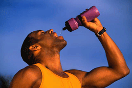 man drinking from a water bottle