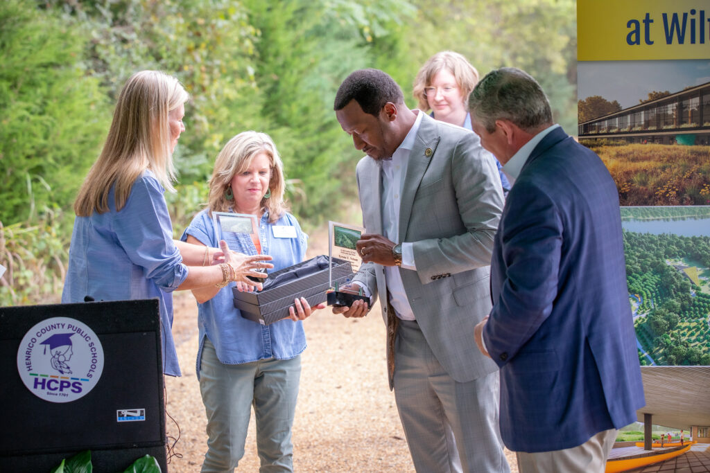 Varina Supervisor Tyrone Nelson and County Manager John Vithoulkas receive plaques from Superintendent Amy Cashwell for their support for the Living Building project.