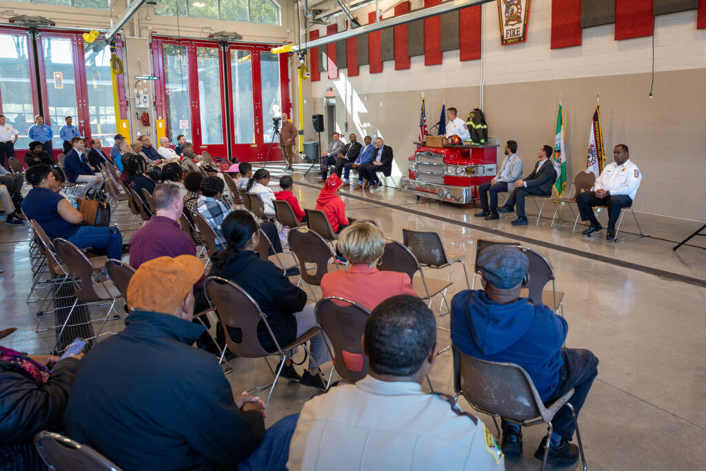 Fire Chief Jackson Baynard speaks to a crowd of guests at the opening of Firehouse 23.