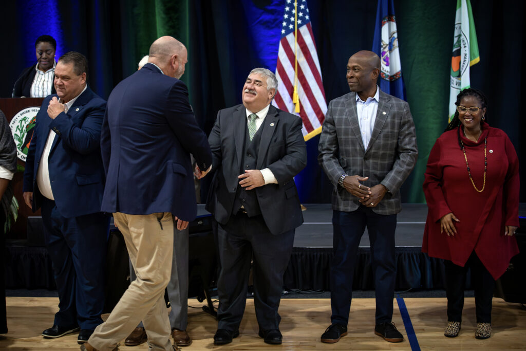 An official shakes the hand of a business representative on receiving a Legacy award for many years of service to Henrico.