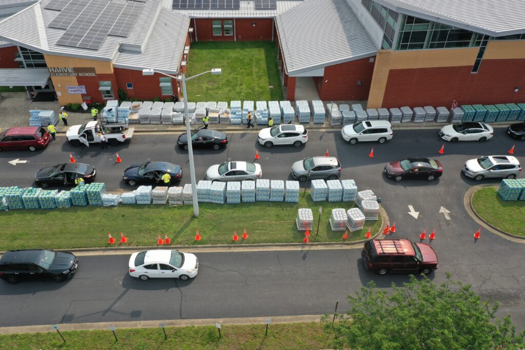 Aerial photo of cars lining up for water at Harvie Elementary School