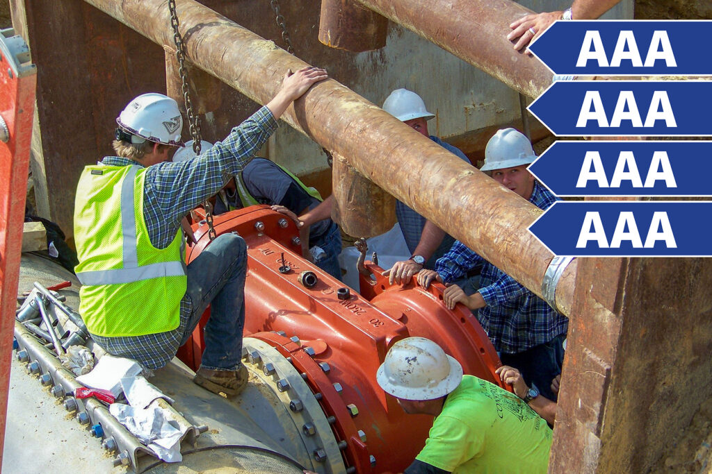 Utilities crews working on a large water main with four sets of AAA.