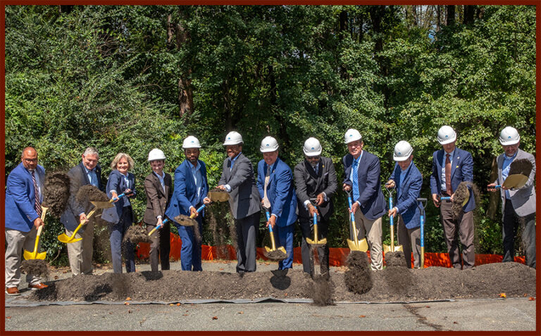 Line of adults with shovels for the ceremonial kick-off of the project