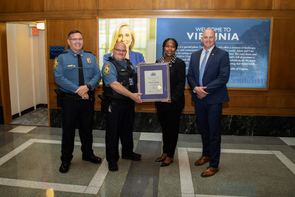 Henrico Police officers receiving the recertification certificate from the Virginia DCJS for the Certified Crime Prevention Community Program.