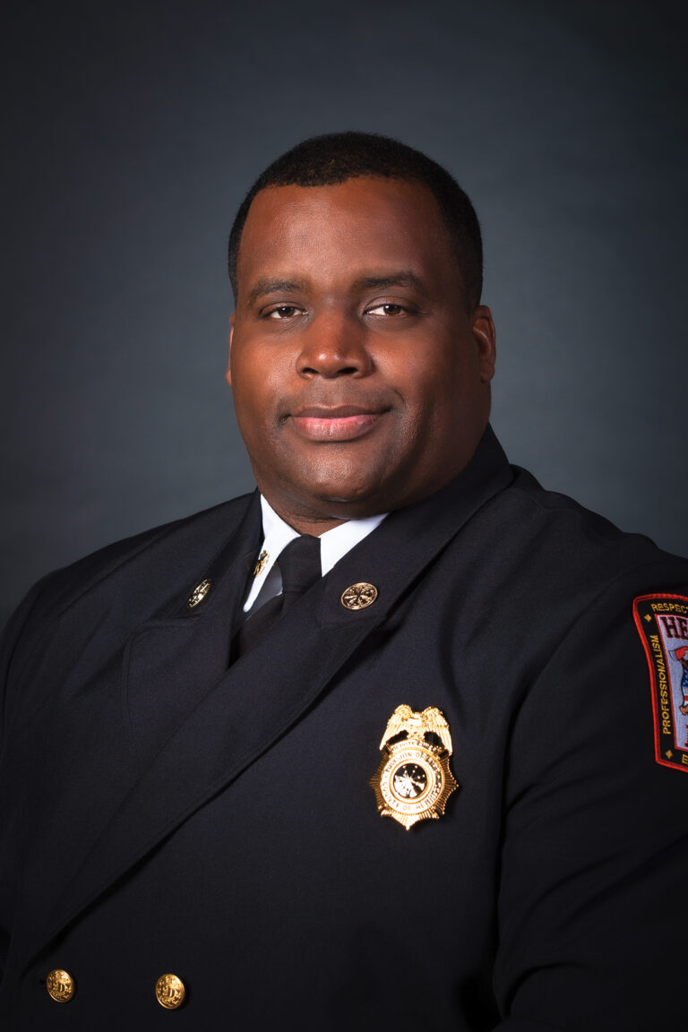 Formal portrait of Douglas Clevert in formal Fire uniform with badge displayed.