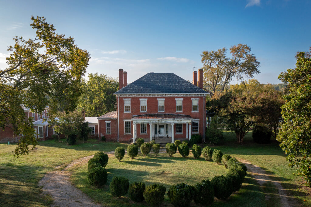 Photo of a Classical Revival-style brick home in Varina.