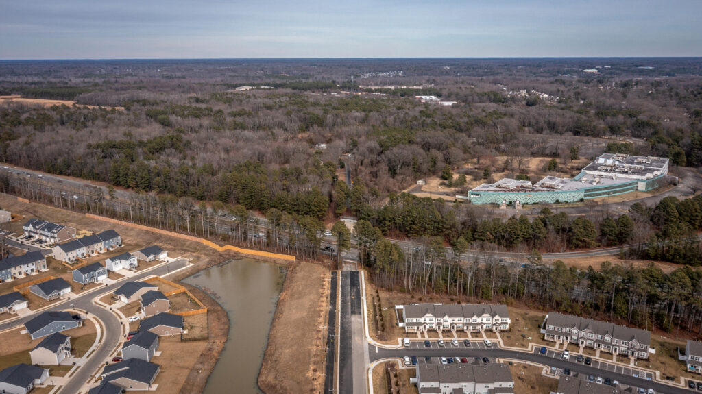 Aerial photo of a wooded area along a highway.