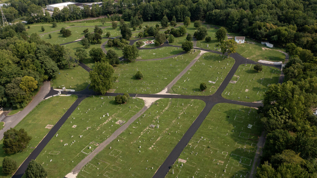 An aerial photo of a cemetery with newly paved roads.
