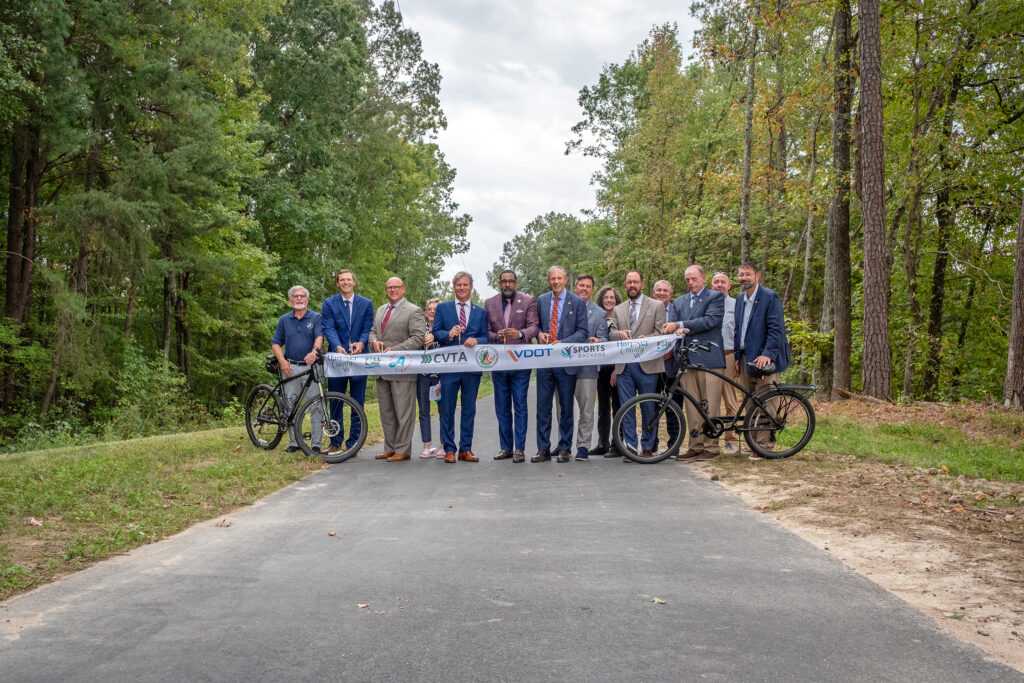 Officials from the region prepare to cut the ribbon to celebrate the opening of the Fall Line trail's northern section.