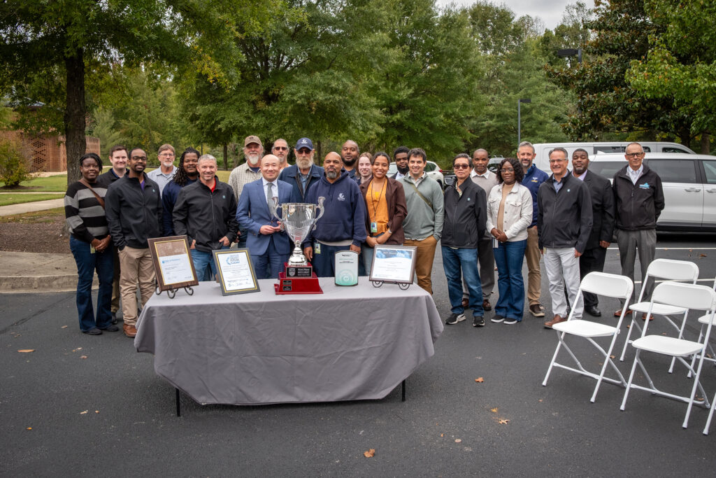 Henrico Public Utilities staff with awards on a table.