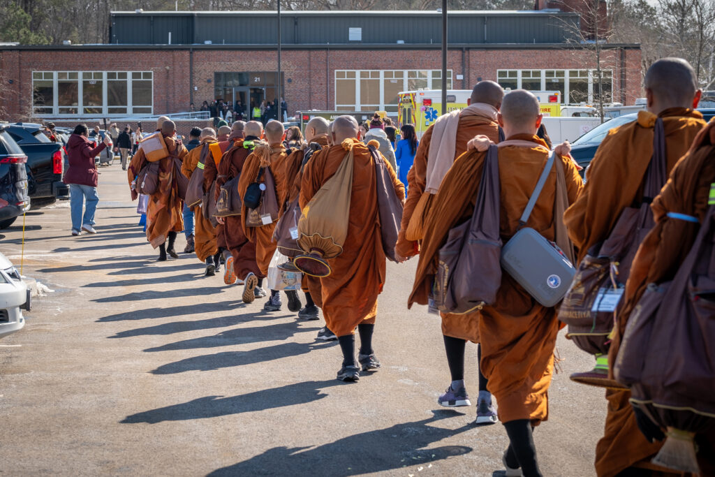 A group of monks walk past.