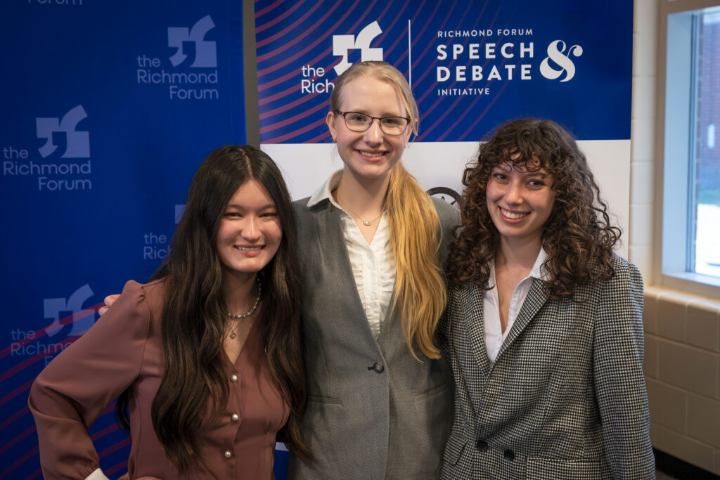 Three high schools students pose for a photo.