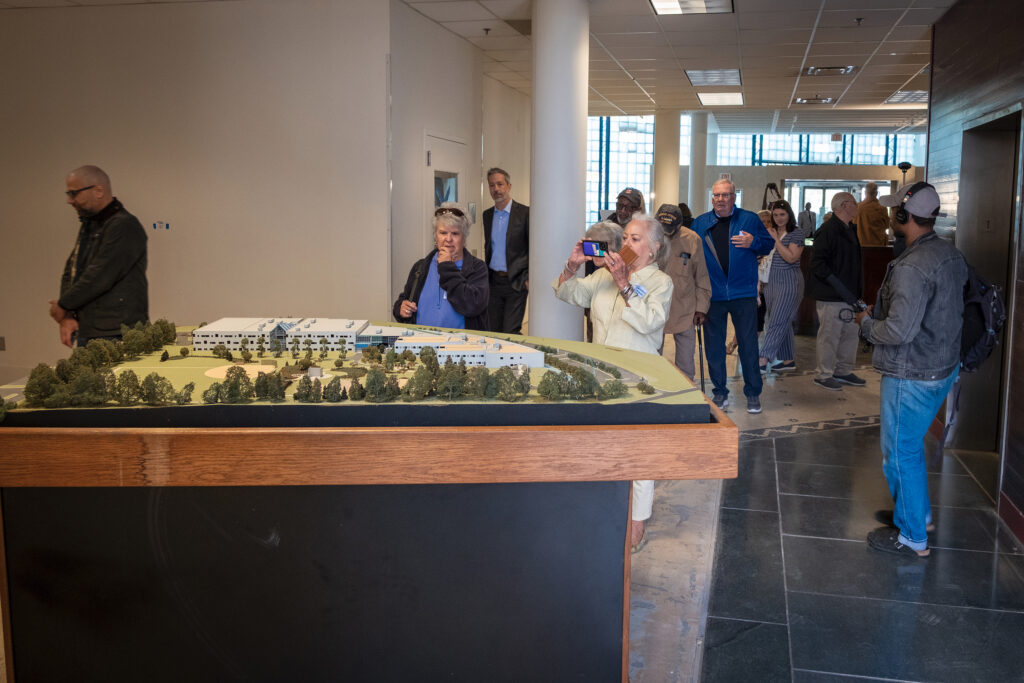 People view a model of a building.