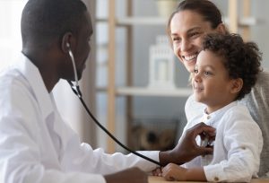 photo of a doctor with a child and mother