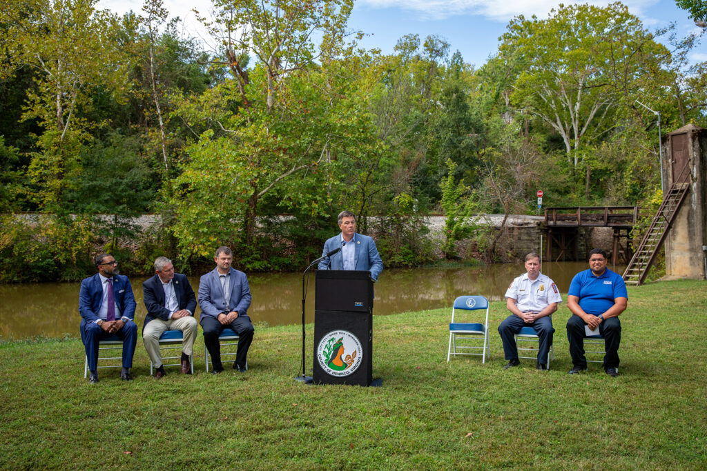 Officials speak at a news conference by the Kanawha Canal.