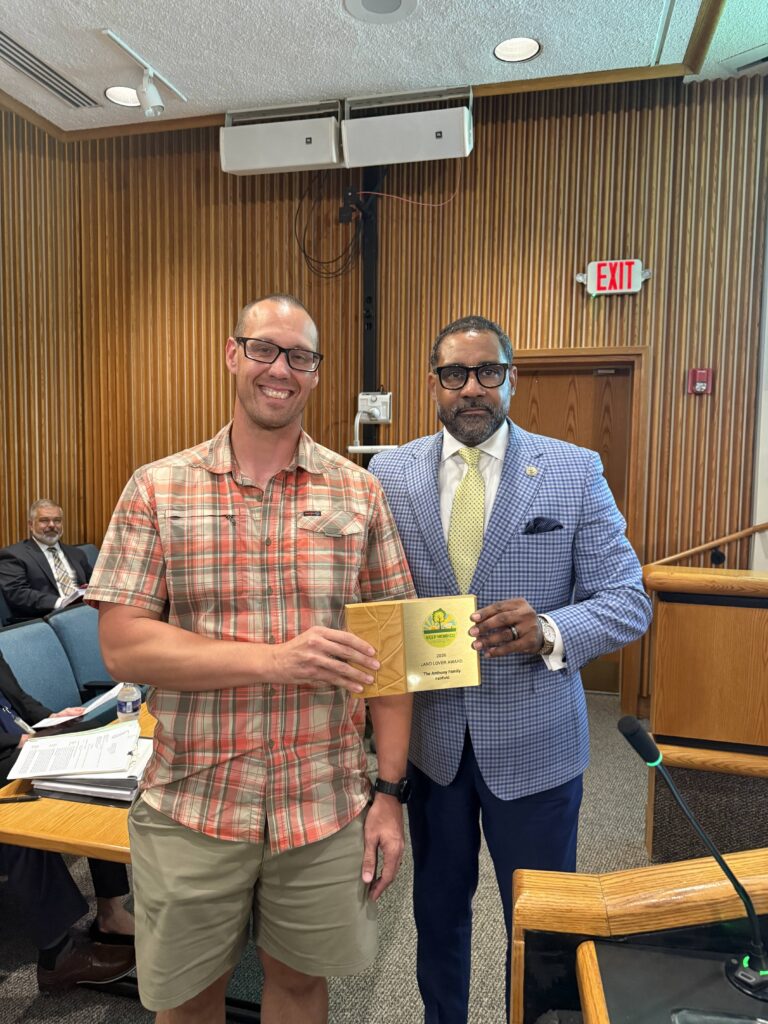 Fairfield Supervisor Roscoe Cooper is shown with a member of the Anthony family who won a 2026 Land Lover award for their property in the Fairfield District.