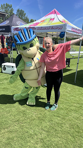 Stewart the turtle strikes a pose in his bike helmet with an event participant.