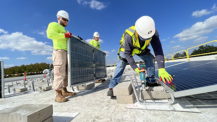 Several workers installing solar panels