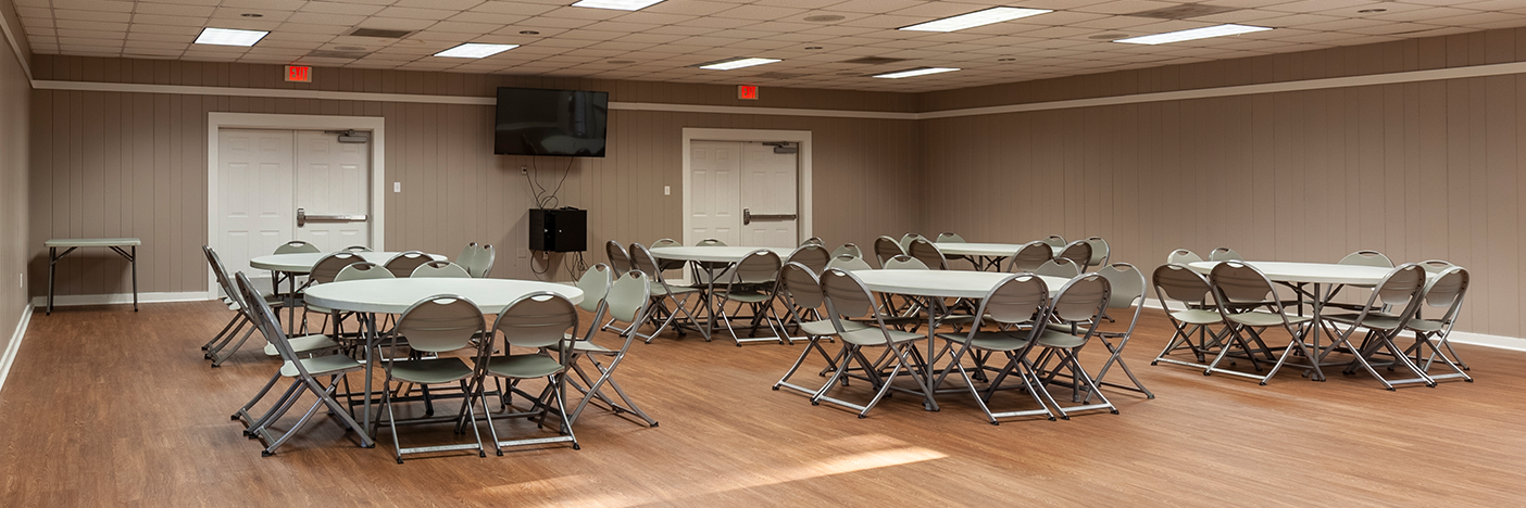Interior of Hunton with round tables and chairs set up.