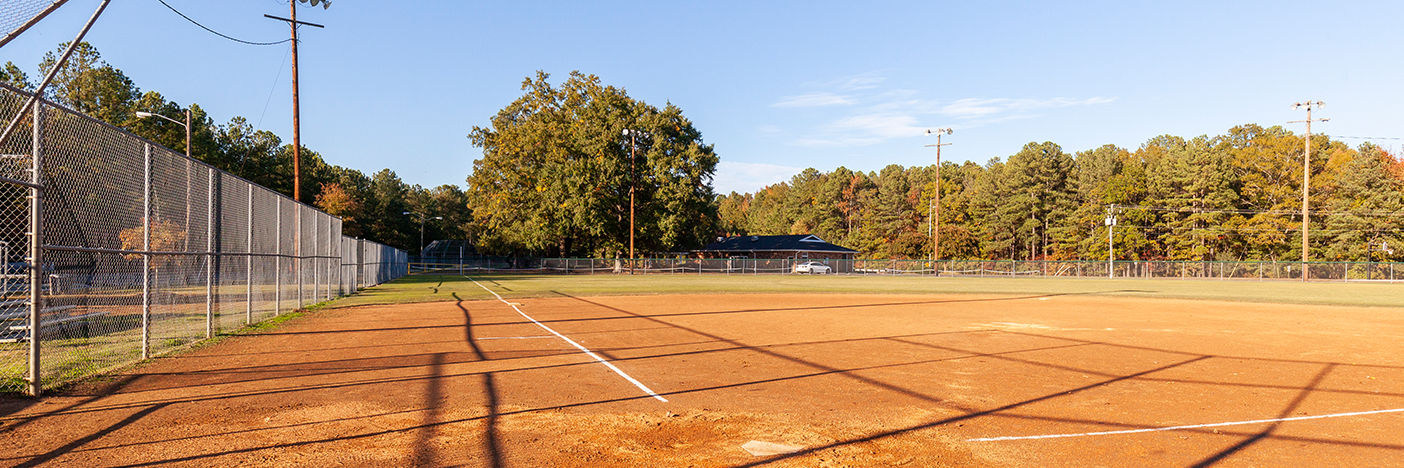 Diamond field with Hunton Community Center and trees in the background.