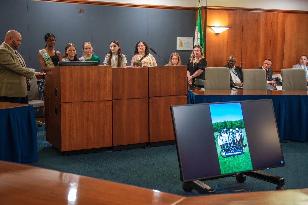 The Board watches a screening of the video made by members of Girl Scouts Troop 5740 on bike safety.