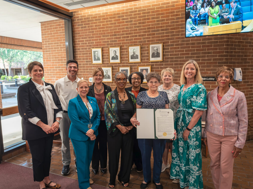 Library workers and supporters hold a proclamation for National Library Week.