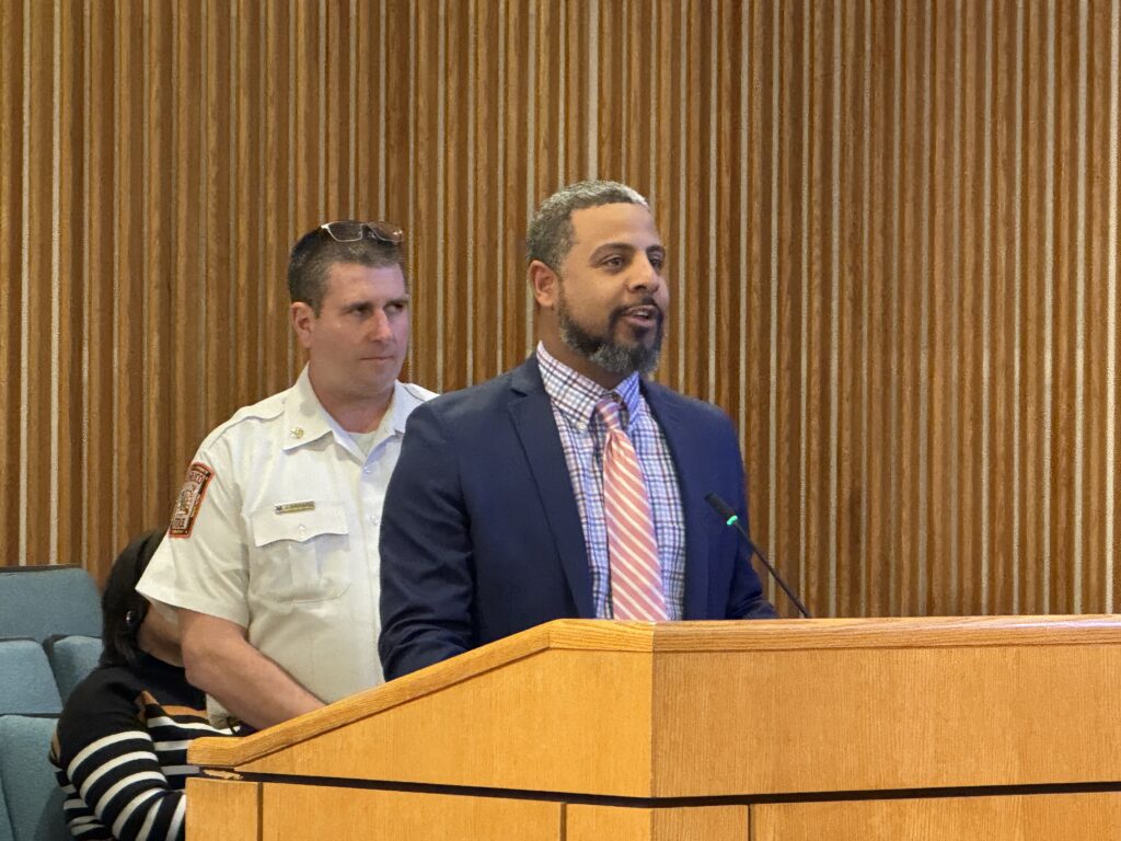 Terrell Hughes stands at the podium in the Board Room while discussing Winter Storm Fern response.