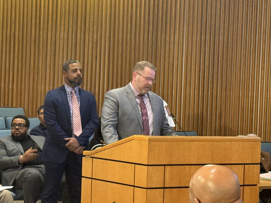 Terrell Hughes stands at the podium in the Board Room while discussing Winter Storm Fern response.