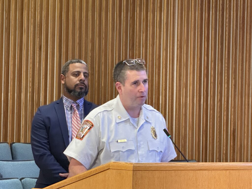 Jackson Baynard stands at the podium in the Board Room while discussing Winter Storm Fern response.