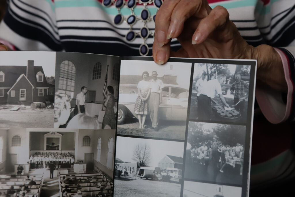 A booklet of black and white photos shows a young couple leaning against a car.