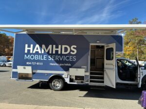 Henrico Area Mental Health and Developmental Services Mobile Unit in a parking lot with the door open and the canopy open.