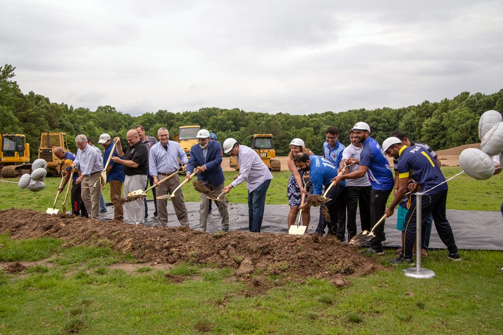 Group shoveling dirt for groundbreaking