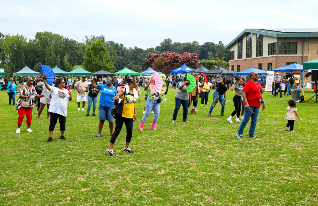 People line dancing at National Night Out.