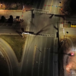 Intersection of Nuckols and Twin Hickory after the installation of solar lights. The aerial view shows high visibility on the roadways but shadows still in the wooded areas near the road.