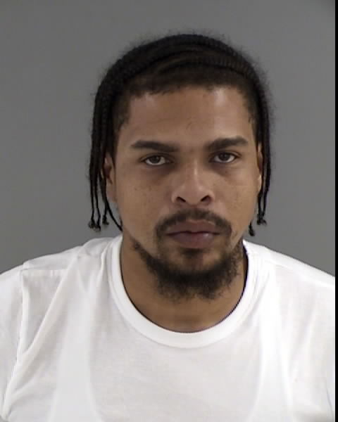 Image shows a Black male with black medium length braids and a goatee