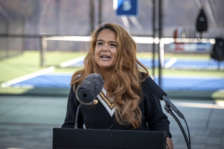 Misty Roundree speaking at a podium.