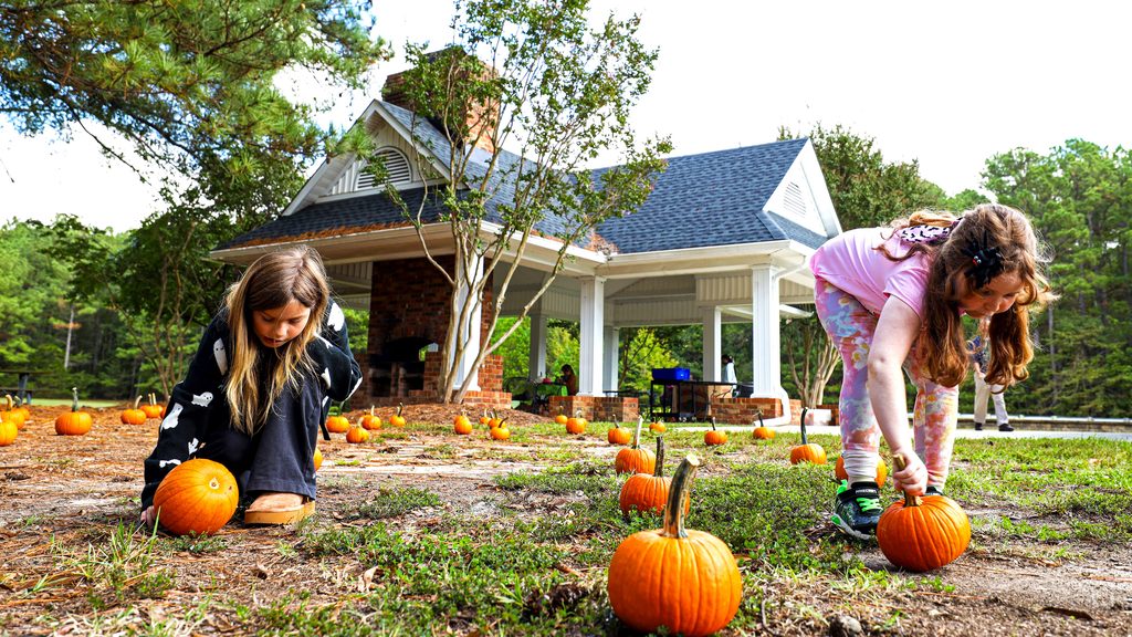 Girls picking pumpkins at the pumpkin decorating program. 