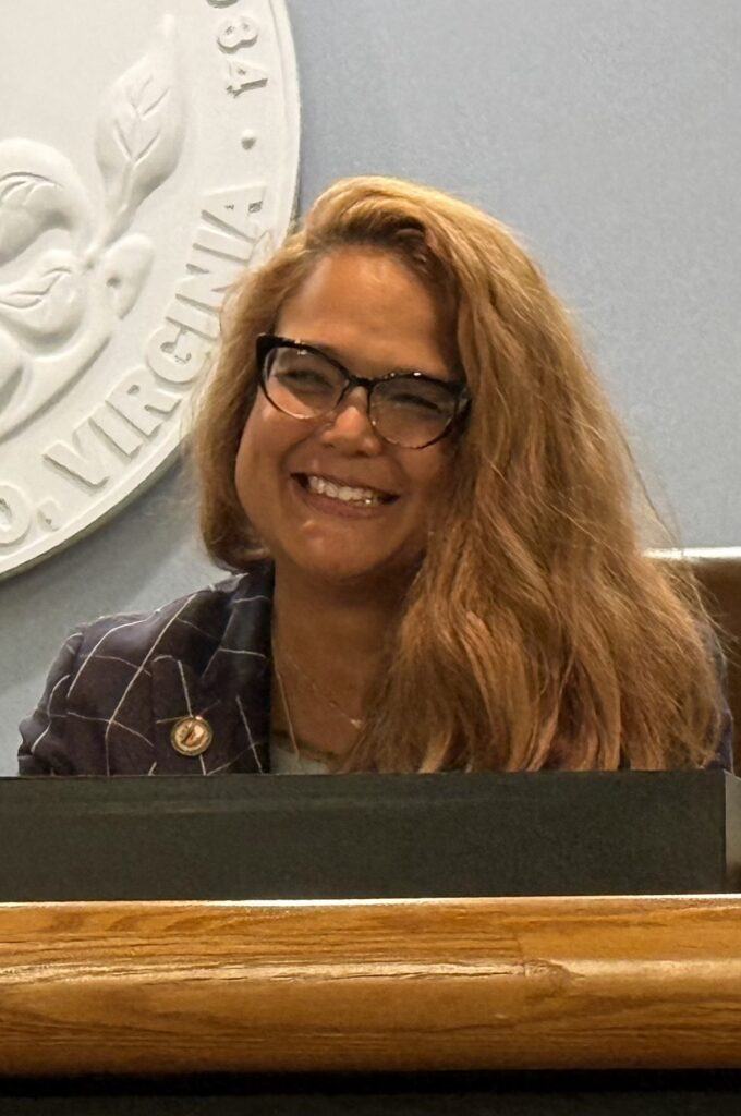 Three Chopt Supervisor Misty Roundtree smiles at a Board of Supervisors meeting.