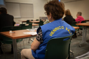 Image shows a Triad-S.A.L.T. member with brown hair wearing a blue vest with the words Henrico S.A.L.T. on the back